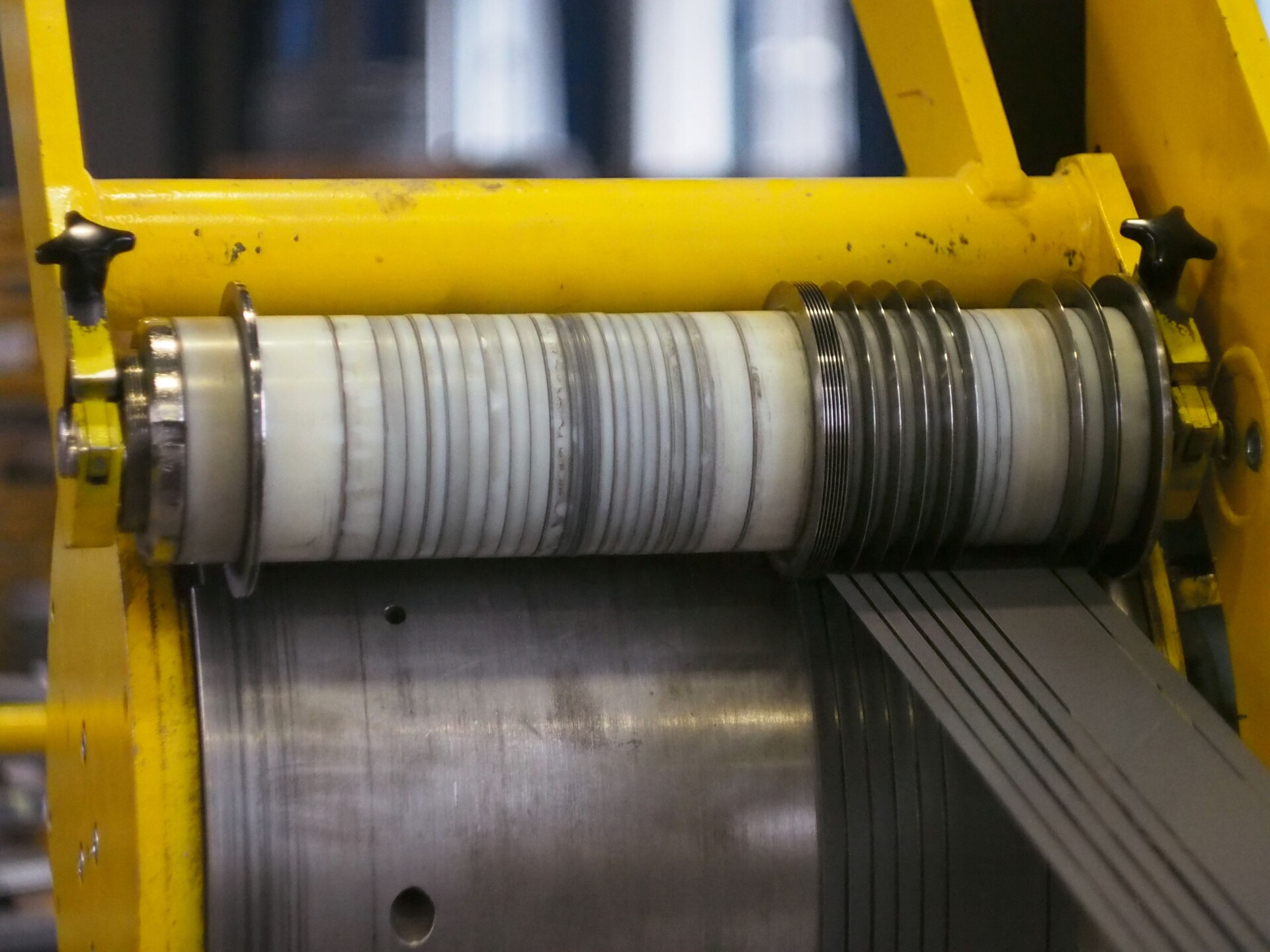 Longitudinal slitting line in action, with metal sheets being accurately cut into desired widths.