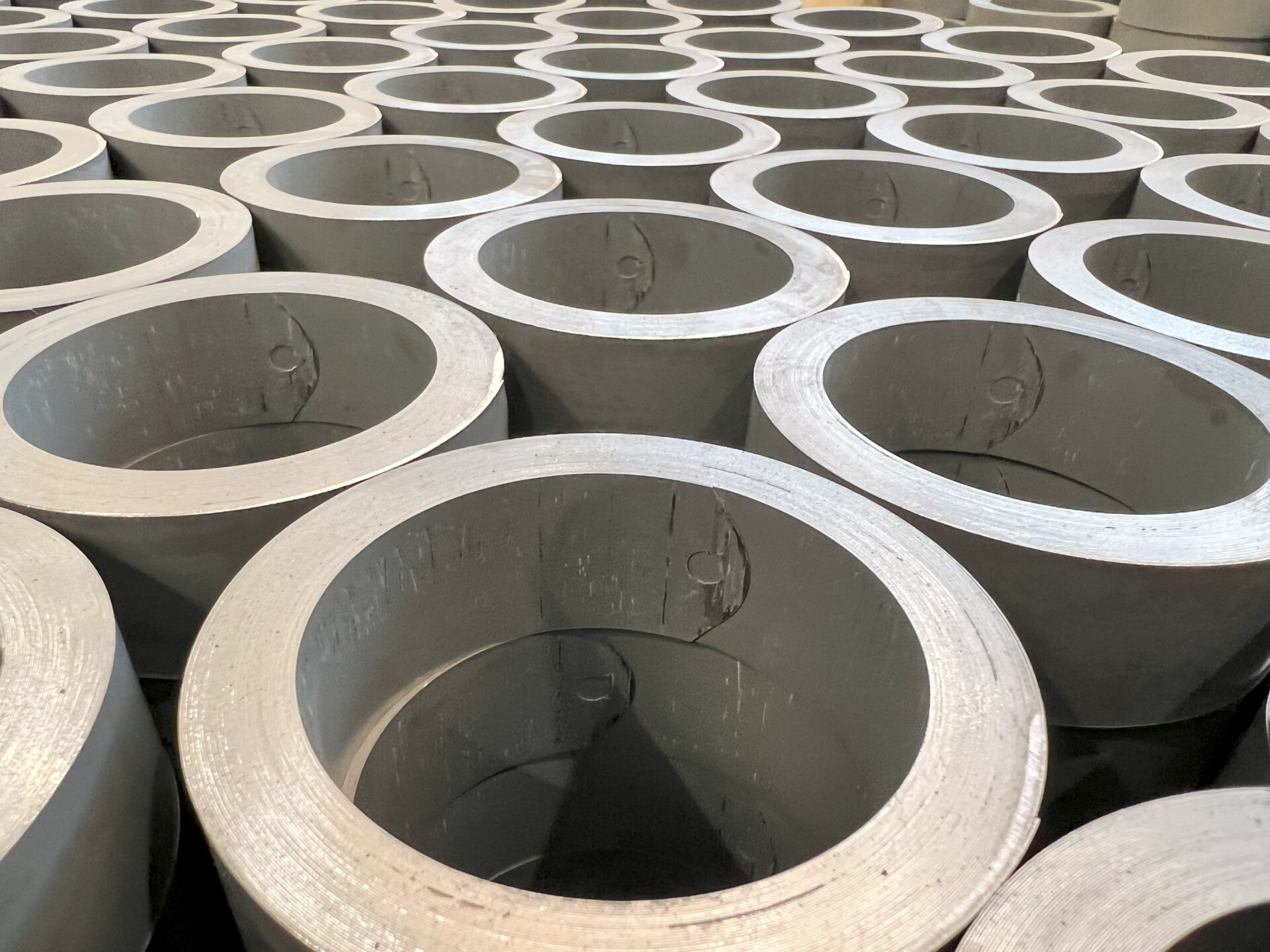 Toroidal cores undergoing the firing process in a kiln to achieve optimal hardness and properties for high-frequency applications and transformers.