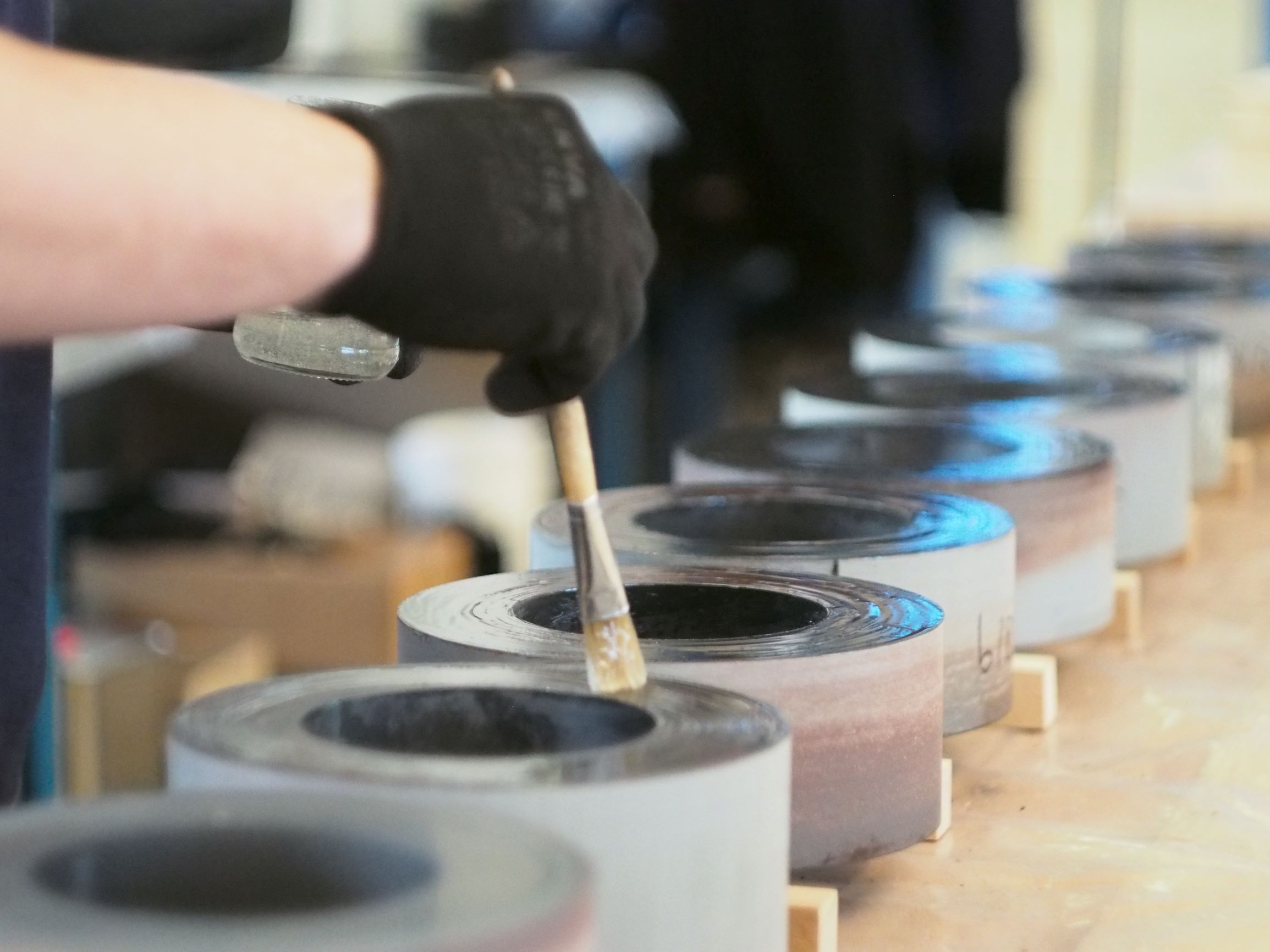 Hand-painted toroidal cores coated with epoxy for enhanced corrosion resistance and electrical insulation. This process ensures long-lasting durability and reliability